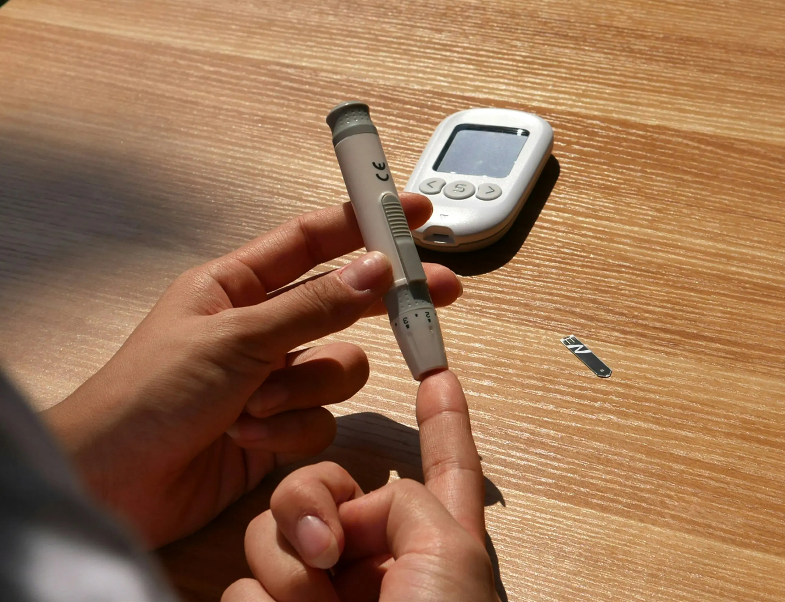 Person testing blood sugar levels with a glucose meter